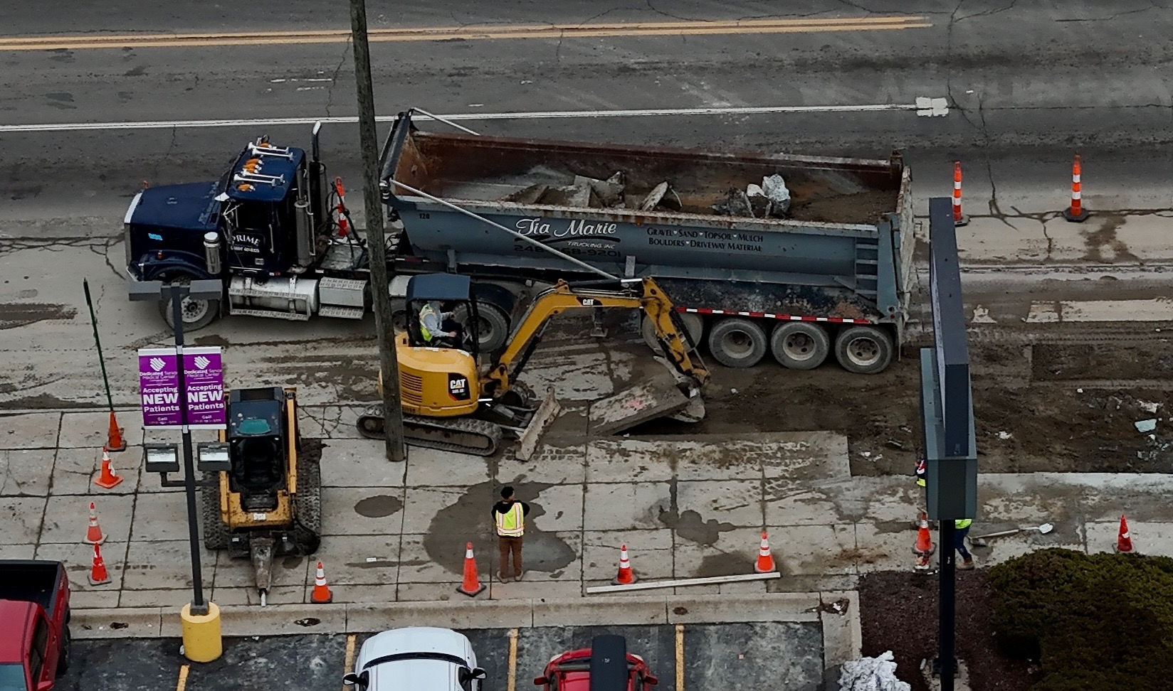 Prime equipment removing concrete and loading debris in Detroit